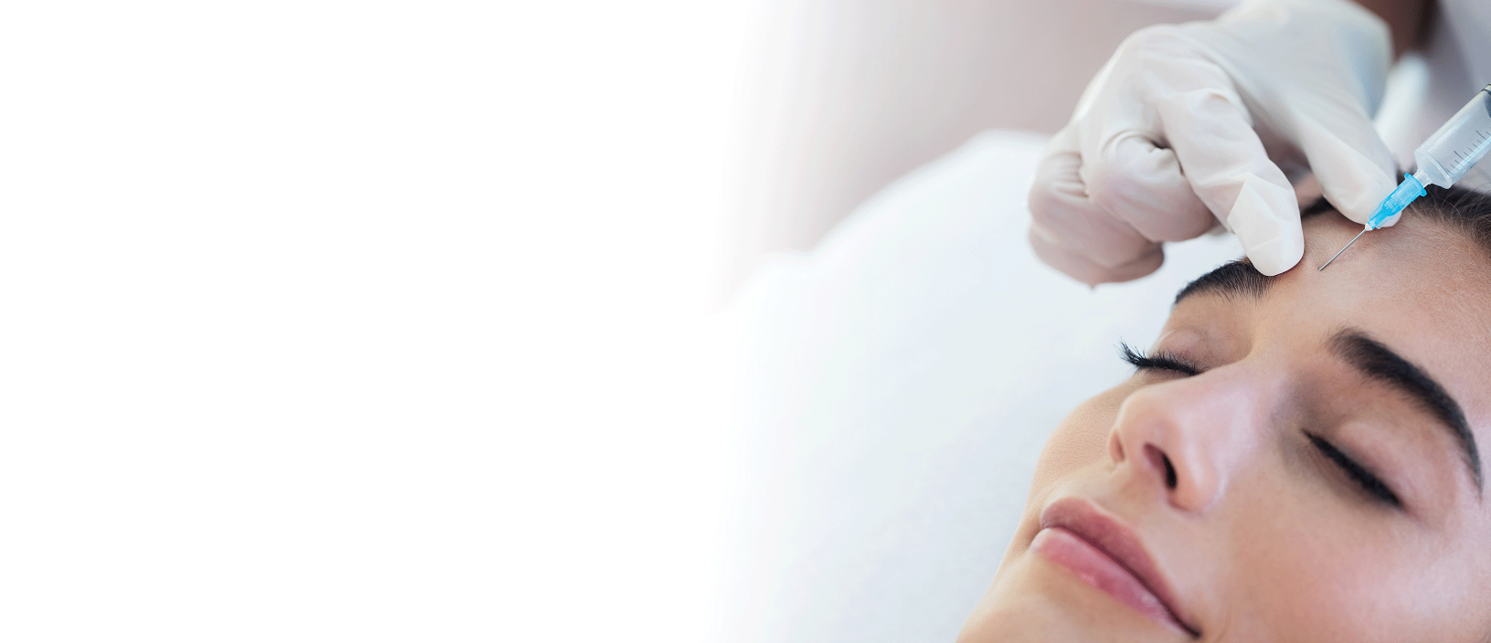 Woman receiving aesthetic injectables from a nurse practitioner in her forehead